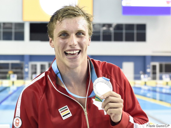 Second place finisher Santo Condorelli, of Canada, poses with his medal after the men's 100m freestyle swimming event at the 2015 Pan Am Games in Toronto on Tuesday, July 14, 2015. THE CANADIAN PRESS/Frank Gunn